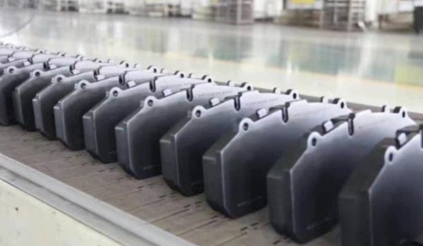 Clean the backing plates and apply adhesive coating.