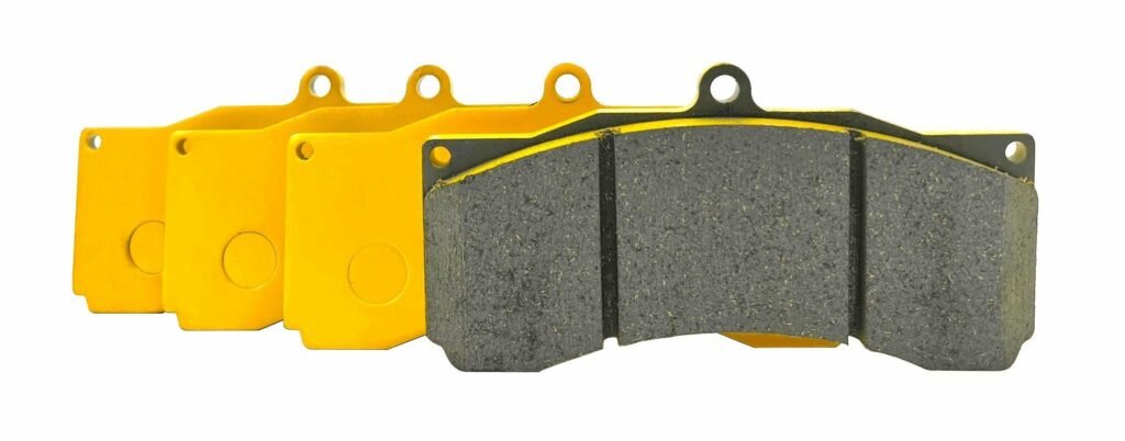 brake pads with different colors showing backing plate coating variations and friction material surface, illustrating that color does not determine brake pad performance