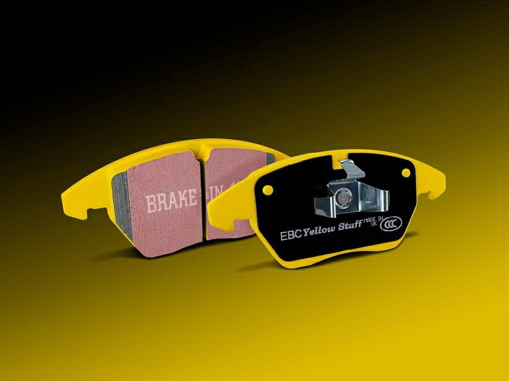 EBC yellow brake pads showing friction material surface and backing plate, illustrating branded color coding in aftermarket brake pad product lines