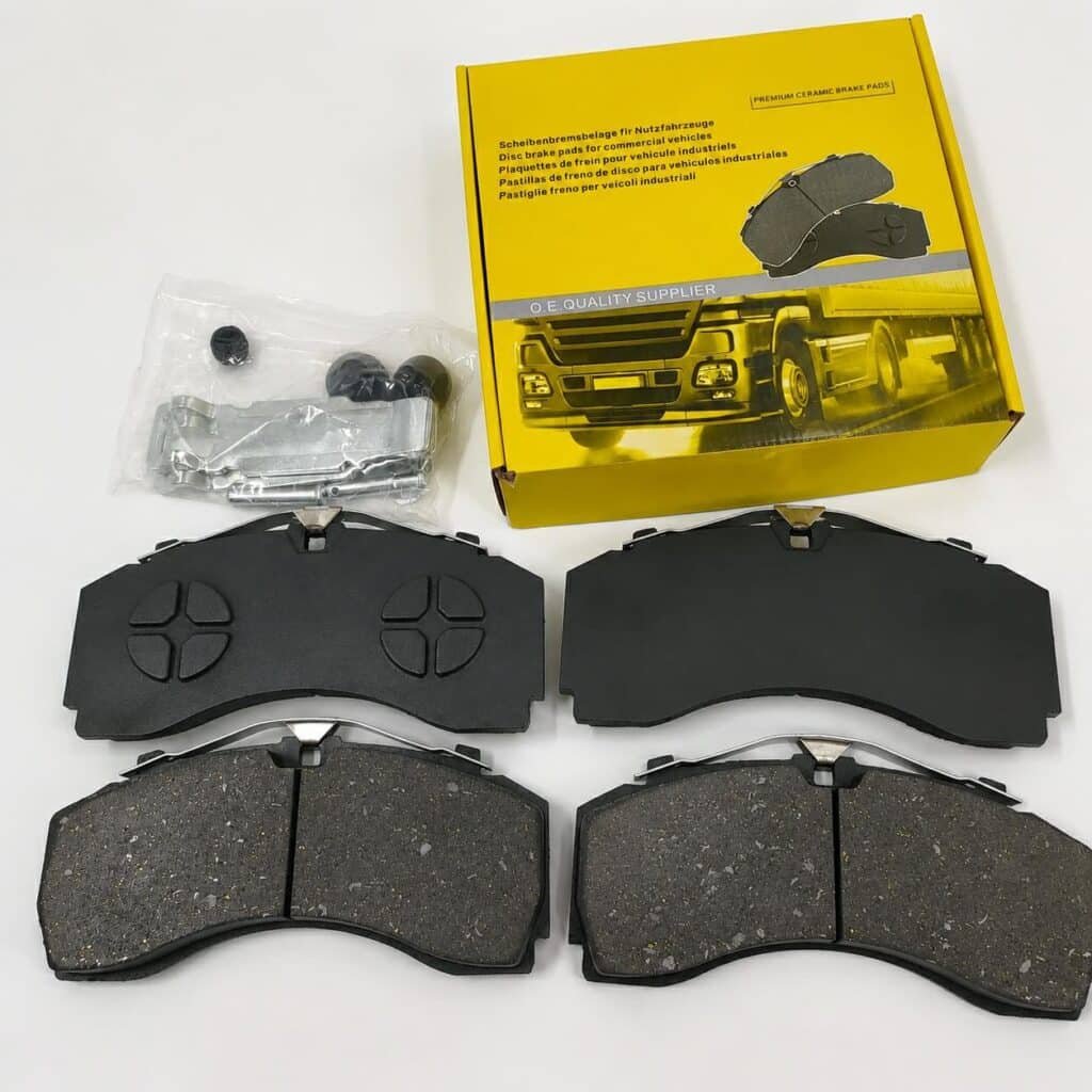 Brake pads product set with packaging and installation hardware showing OEM quality ceramic brake pads for commercial vehicle aftermarket B2B buyers and distributors