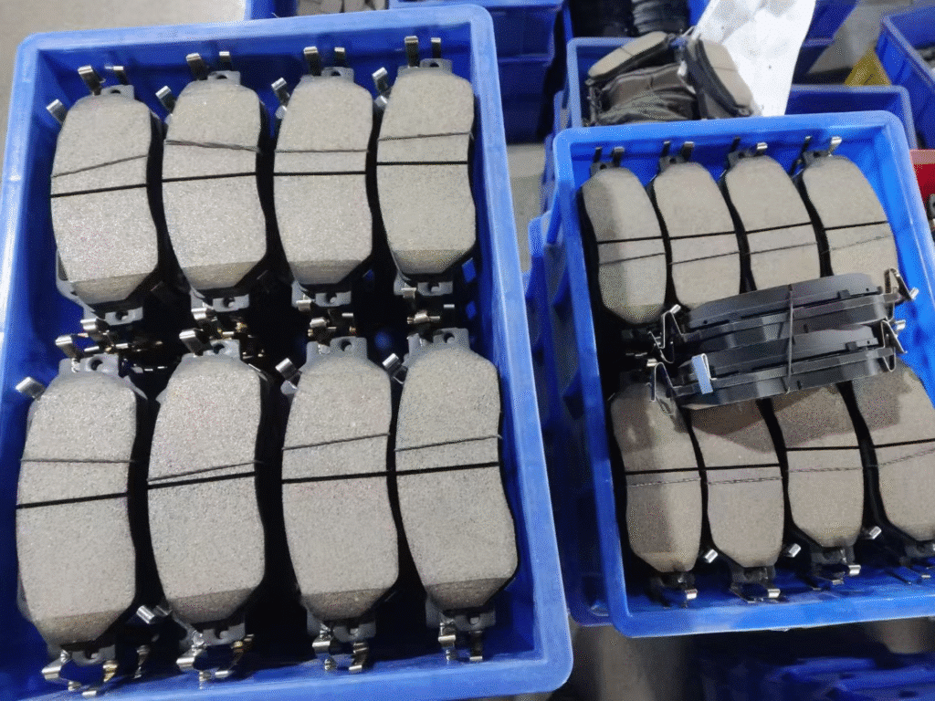 Pilot-batch commercial vehicle brake pads arranged in bins for production quality inspection and field validation